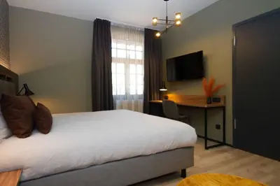 Ein Bett oder Betten in einem Zimmer der Unterkunft DAS Hotel by Hopfenschlingel