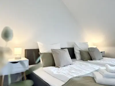Ein Bett oder Betten in einem Zimmer der Unterkunft MyStay I Central Lofts I Superior Design Apartments Heidelberg