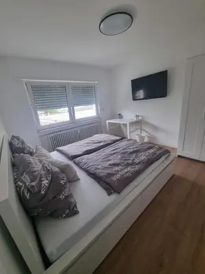 Ein Bett oder Betten in einem Zimmer der Unterkunft ~Ferienwohnung Sandhausen / HD~