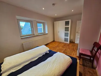 Ein Bett oder Betten in einem Zimmer der Unterkunft Kiwihof Ferienhaus Südpfalz