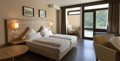 Ein Bett oder Betten in einem Zimmer der Unterkunft Hotel Luisenpark