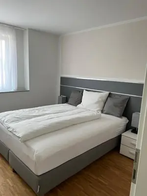 Ein Bett oder Betten in einem Zimmer der Unterkunft New Age Boardinghaus Bad Wimpfen