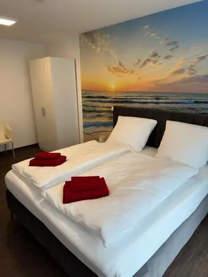 Ein Bett oder Betten in einem Zimmer der Unterkunft Barrierefreie Ferienwohnungen in der Nähe der Golf- und Freizeitanlage