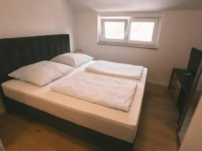 Ein Bett oder Betten in einem Zimmer der Unterkunft Ferienwohnung Weissach