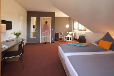 Ein Bett oder Betten in einem Zimmer der Unterkunft Hotel Astra Rastatt