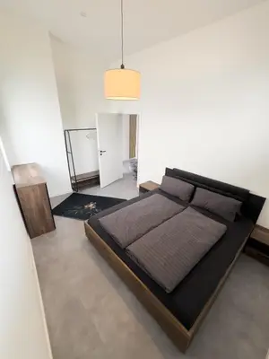 Ein Bett oder Betten in einem Zimmer der Unterkunft Apart das Ehrets mit 3 Schlafzimmer