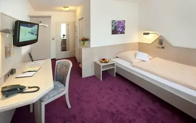 Ein Bett oder Betten in einem Zimmer der Unterkunft Hotel Malchen Garni