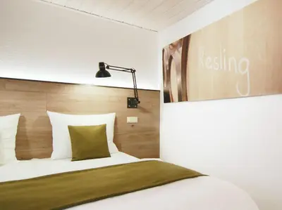 Ein Bett oder Betten in einem Zimmer der Unterkunft Weingut-Gästehaus Buchert