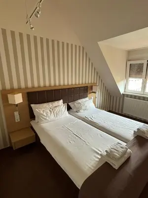 Ein Bett oder Betten in einem Zimmer der Unterkunft Hotel Ortel GmbH