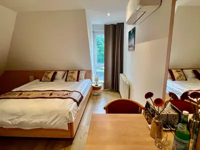 Ein Bett oder Betten in einem Zimmer der Unterkunft Gästehaus LINH