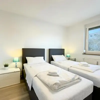 Ein Bett oder Betten in einem Zimmer der Unterkunft Parkplatz - Zentral - modern - 3-Zi 5x Pers