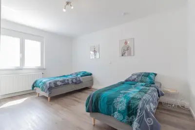 Ein Bett oder Betten in einem Zimmer der Unterkunft nJoy! Apartment Heilbronn - Zentral & Garten