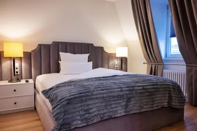 Ein Bett oder Betten in einem Zimmer der Unterkunft Kleiner Rosengarten