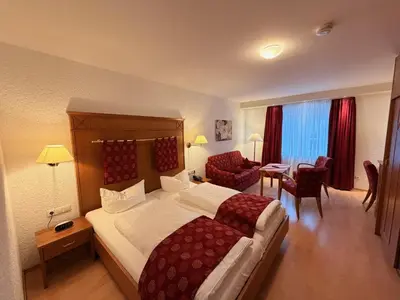 Ein Bett oder Betten in einem Zimmer der Unterkunft Ringhotel Siegfriedbrunnen