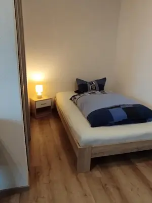 Ein Bett oder Betten in einem Zimmer der Unterkunft Ferienwohnung Zur Schönen Aussicht im Odenwald