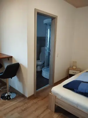 Ein Bett oder Betten in einem Zimmer der Unterkunft Ferienwohnung Zur Schönen Aussicht im Odenwald