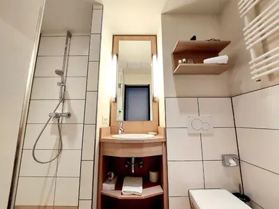 Ein Badezimmer in der Unterkunft Heinrich Pesch Hotel