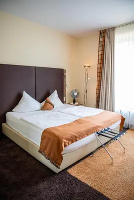 Ein Bett oder Betten in einem Zimmer der Unterkunft Hotel am Schlosspark