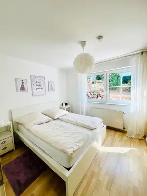 Ein Bett oder Betten in einem Zimmer der Unterkunft Moderne & gemütliche Ferienwohnung mit Terasse in Nieder-Olm