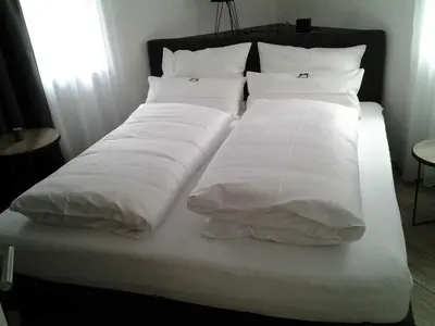 Ein Bett oder Betten in einem Zimmer der Unterkunft Malerwinkel & Tuchereck