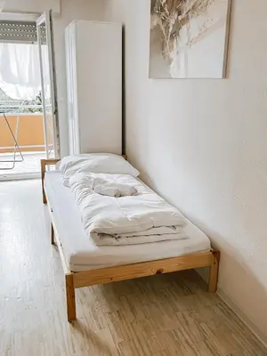 Ein Bett oder Betten in einem Zimmer der Unterkunft DoreyHome HN1 - Stilvolles Apartment zentral in Heilbronn - 7 Personen - WLAN
