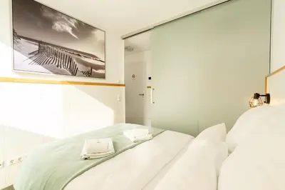 Ein Bett oder Betten in einem Zimmer der Unterkunft Sali Homes Apartmenthaus Schlossgasse