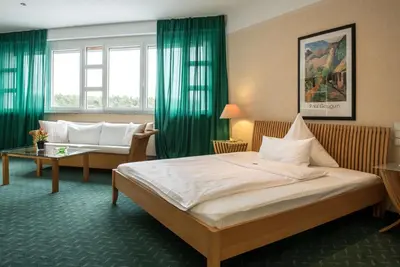 Ein Bett oder Betten in einem Zimmer der Unterkunft Hotel Artrium am Park