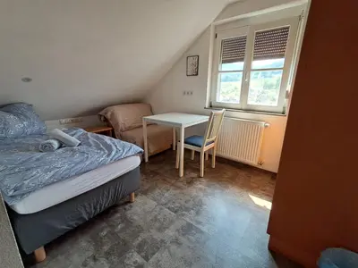 Ein Bett oder Betten in einem Zimmer der Unterkunft Boardinghouse Wildbachtal