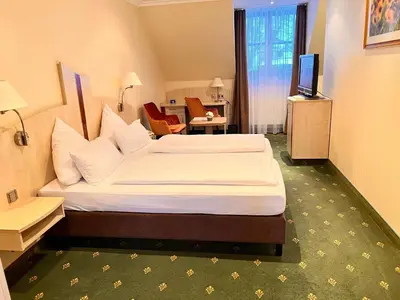 Ein Bett oder Betten in einem Zimmer der Unterkunft Landhotel Heimathenhof