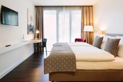 Ein Bett oder Betten in einem Zimmer der Unterkunft Chester Hotel Heidelberg