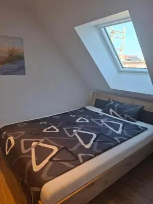 Ein Bett oder Betten in einem Zimmer der Unterkunft Moderne DG-Wohnung mit Flair in guter Lage
