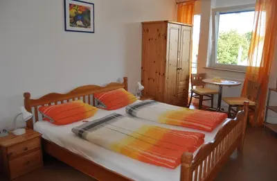 Ein Bett oder Betten in einem Zimmer der Unterkunft Gästehaus Im Unnerdorf