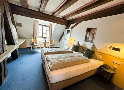 Ein Bett oder Betten in einem Zimmer der Unterkunft Herzogskelter Hotel & Restaurant