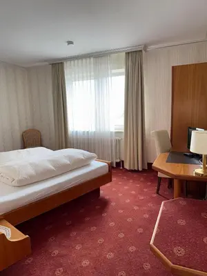 Ein Bett oder Betten in einem Zimmer der Unterkunft ChesaMia Hotel u Appartment