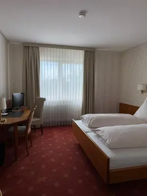 Ein Bett oder Betten in einem Zimmer der Unterkunft ChesaMia Hotel u Appartment