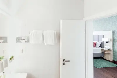 Ein Bett oder Betten in einem Zimmer der Unterkunft Pallas Hotels