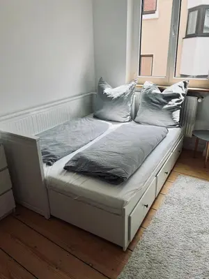 Ein Bett oder Betten in einem Zimmer der Unterkunft Altbauwohnung mit Dachterrasse in der Innenstadt Speyer