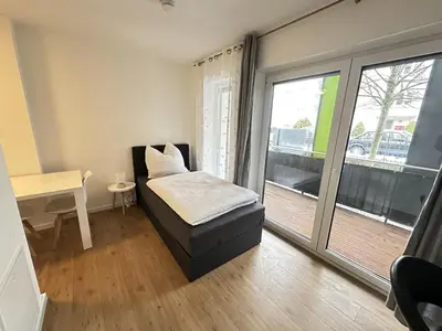Ein Bett oder Betten in einem Zimmer der Unterkunft Business Apartment mit Balkon, 1 Person, zentrumsnah