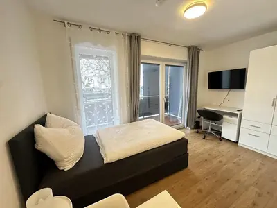 Ein Bett oder Betten in einem Zimmer der Unterkunft Business Apartment mit Balkon, 1 Person, zentrumsnah
