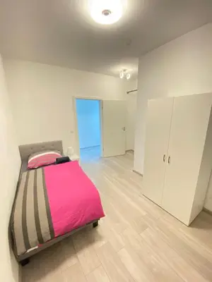 Ein Bett oder Betten in einem Zimmer der Unterkunft Goldstadt