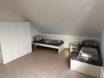 Ein Bett oder Betten in einem Zimmer der Unterkunft 4 Personen I 2 Schlafzimmer I Wohnung Wörrstadt mit Parkplatz