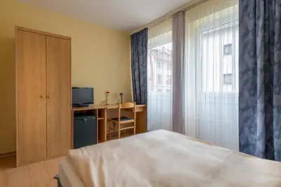 Ein Bett oder Betten in einem Zimmer der Unterkunft Hotel Regina