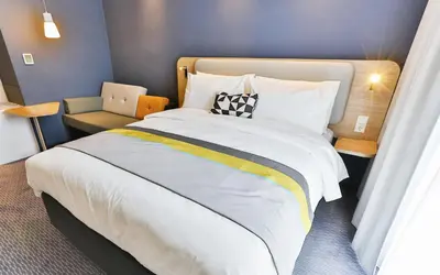 Ein Bett oder Betten in einem Zimmer der Unterkunft Holiday Inn Express Karlsruhe - City Park by IHG