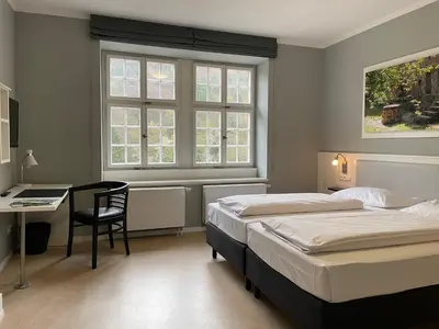 Ein Bett oder Betten in einem Zimmer der Unterkunft Jugendstilhotel Trifels