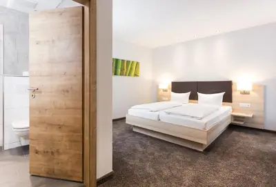 Ein Bett oder Betten in einem Zimmer der Unterkunft Hotel Pfälzer Wald