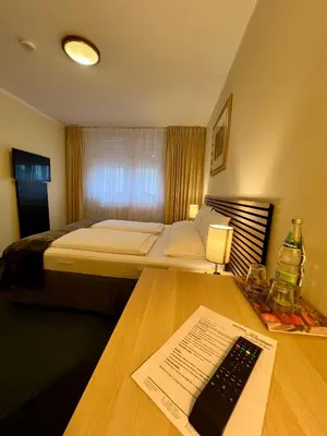 Ein Bett oder Betten in einem Zimmer der Unterkunft Hotel Residenz Stockstadt