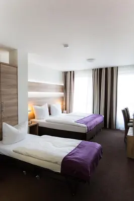 Ein Bett oder Betten in einem Zimmer der Unterkunft Hotel & Restaurant Rose
