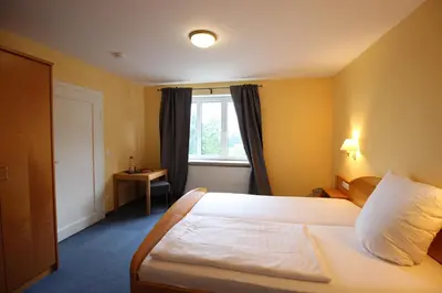 Ein Bett oder Betten in einem Zimmer der Unterkunft Hotel Berghof