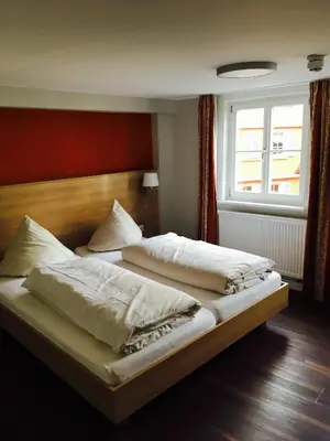 Ein Bett oder Betten in einem Zimmer der Unterkunft Brauereigasthof Krone Öhringen