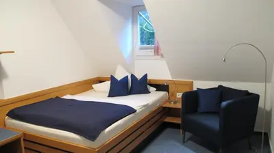 Ein Bett oder Betten in einem Zimmer der Unterkunft Hotel Anlage Heidelberg